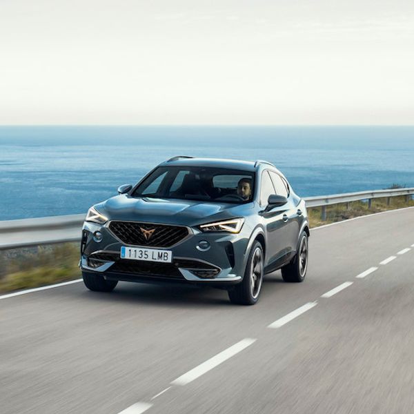 Cupra Formento e-hybrid exterior front driving by sea